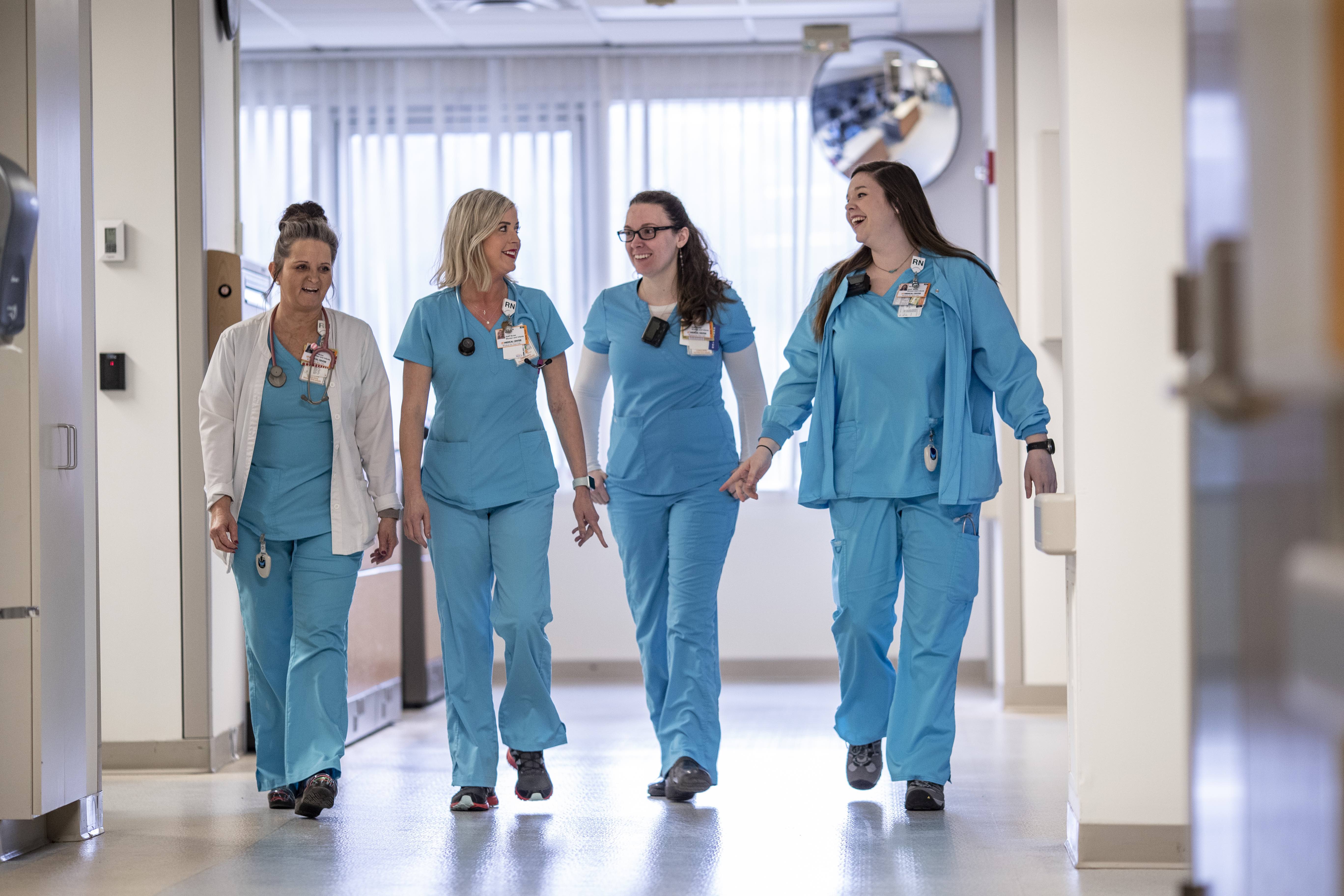 team of nurses walking through hallway