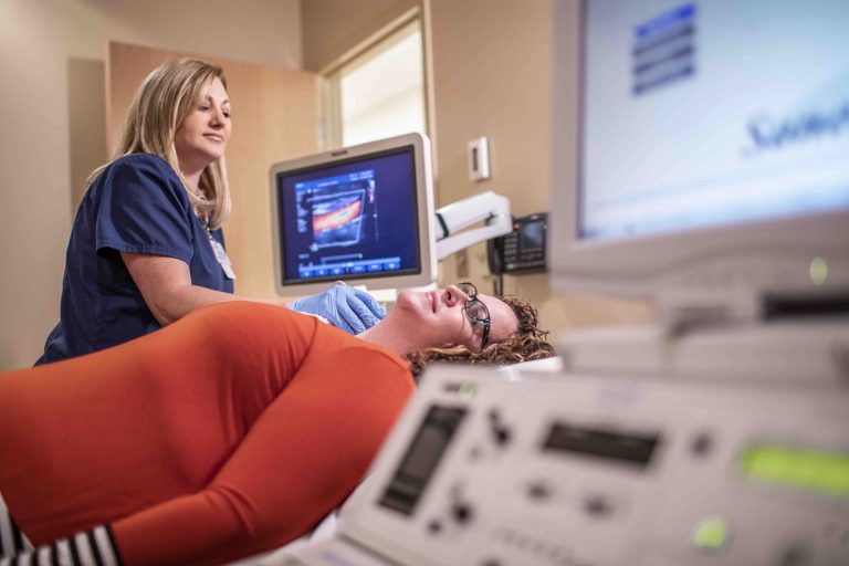 woman on table with nurse at a monitor