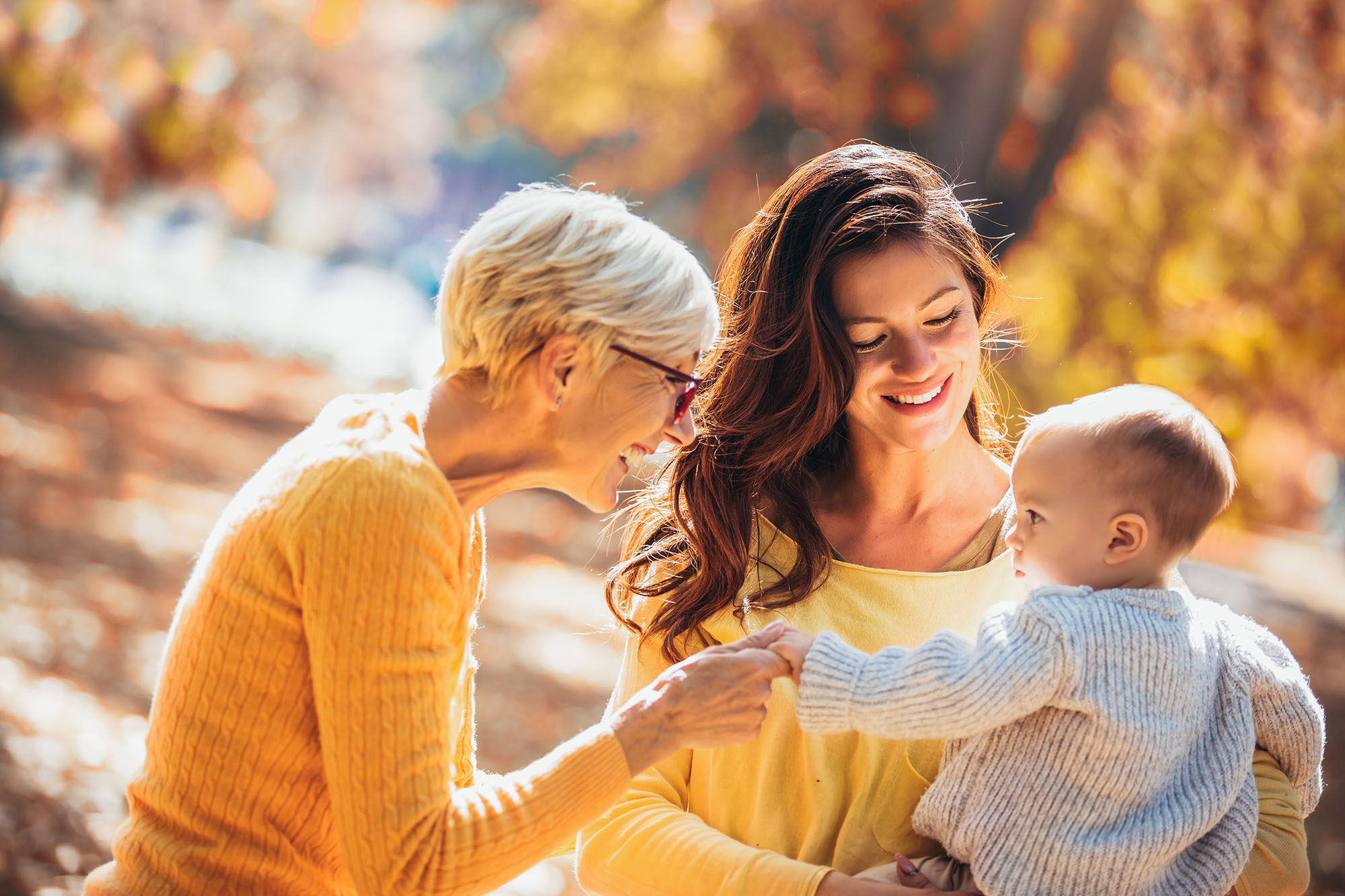 woman and grandmother with newborn outside