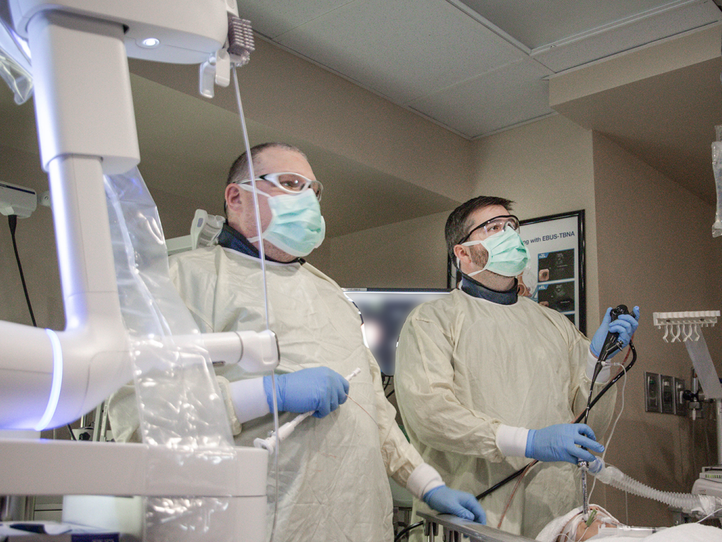 Two doctors performing a lung procedure