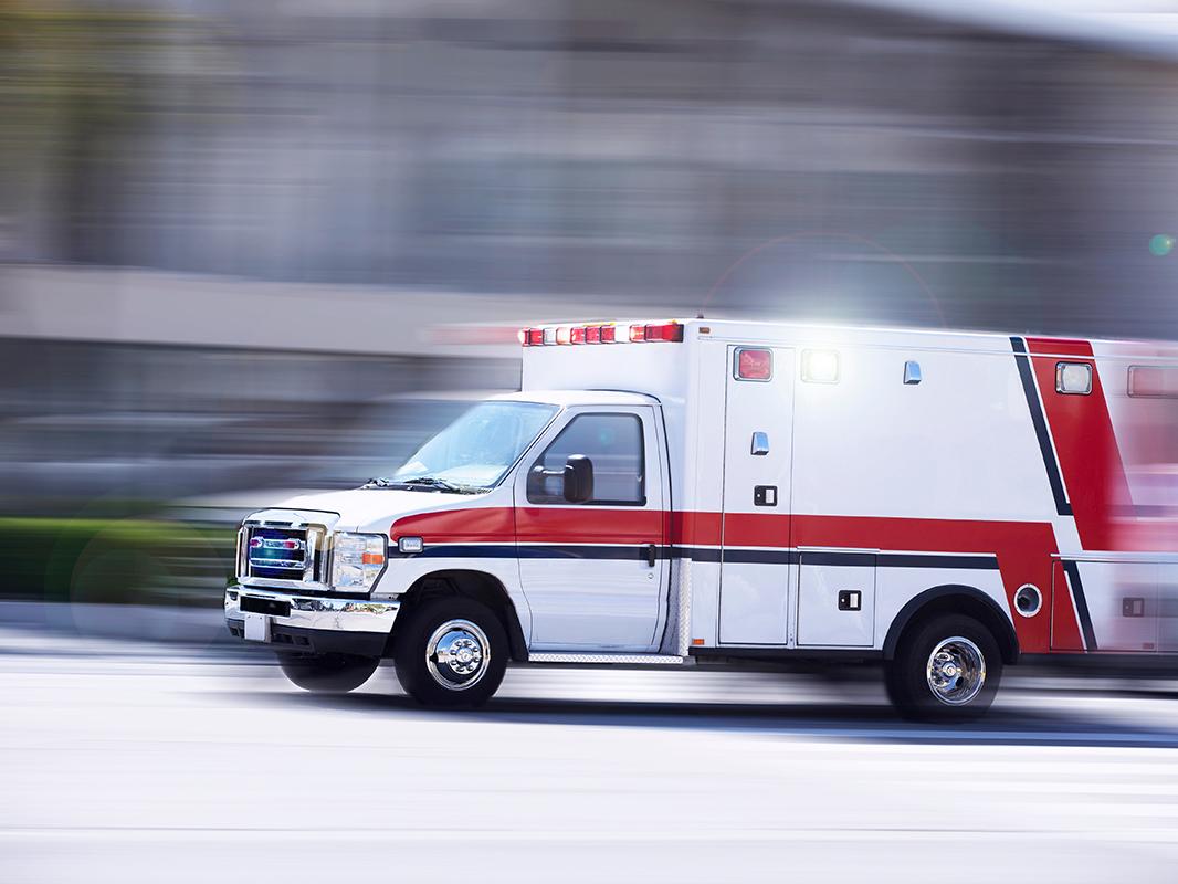 An ambulance speeds down a city street