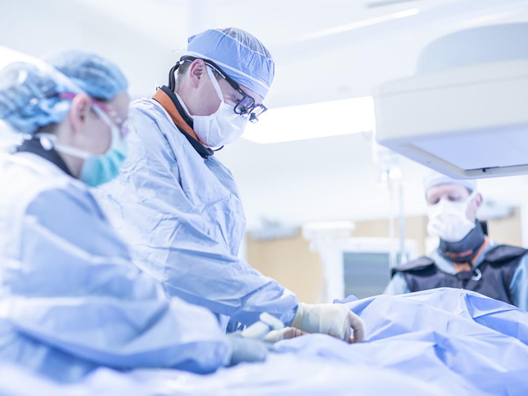 A surgeon operates in an endovascular lab