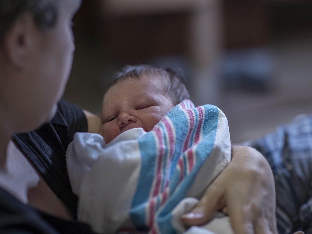 A mom holds a newborn baby