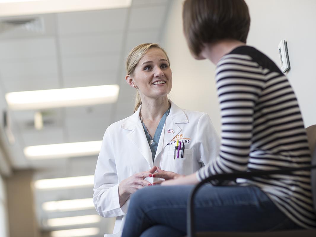 An orthopaedic oncologist talks with a patient