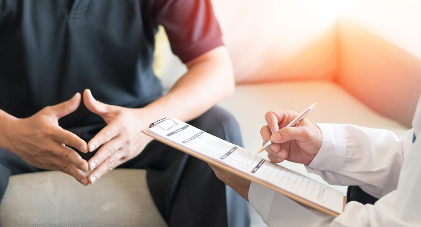 A male patient talks with a doctor