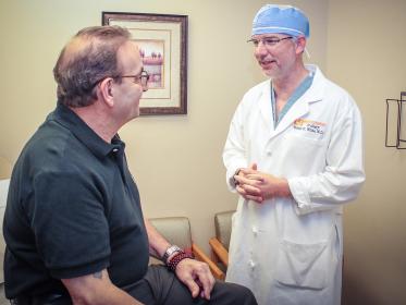 Wes White MD, urologist, talks with a patient