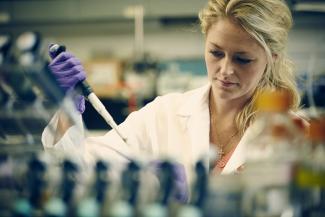 A researcher running tests in a lab