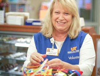 UTMed volunteer tying balloons in the gift shop