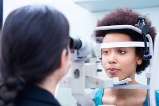 A Black woman gets an eye exam