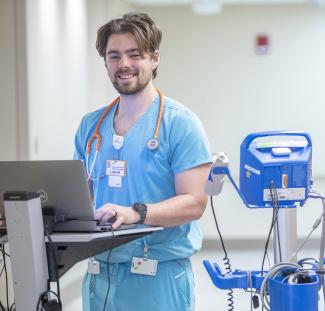 Nurse working at a hallway computer