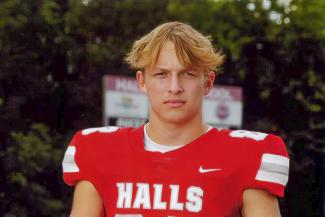 A high school football player in his football uniform