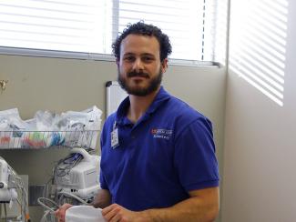 A college-aged volunteer works in a hospital