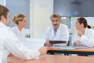A medical team reviewing documents in a conference room