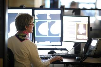 A doctor reads a mammogram on a computer