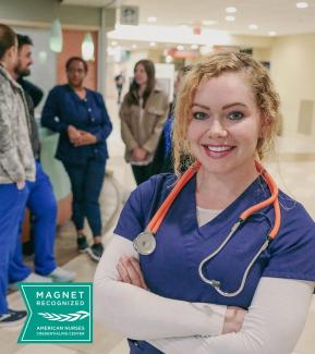 A nurse standing in a hospital lobby