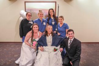 Nurses pose with a family during a wedding at a hospital chapel