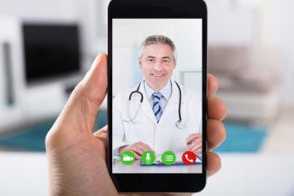 A patient talks with her doctor via phone and telemedicine