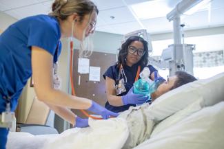 Two respiratory therapists with a patient
