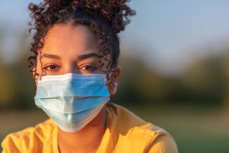 A woman wears a medical mask