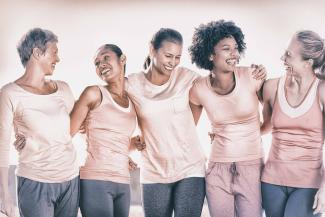 Five women wearing pink t-shirts in honor of breast cancer awareness