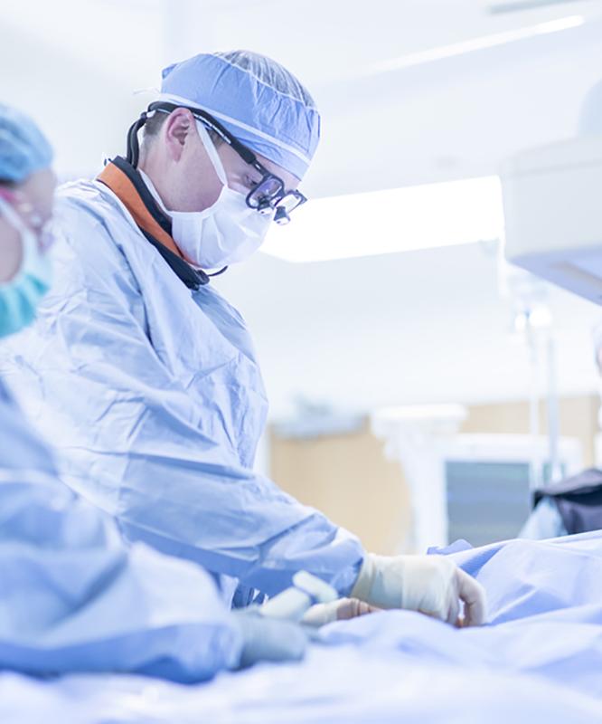 A surgeon operates in an endovascular lab