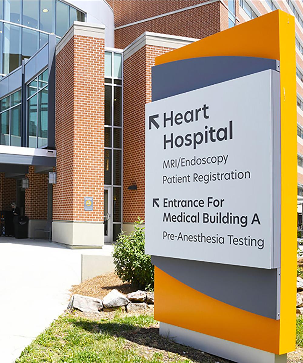 A sign at UT Medical Center showing directions to the Heart Hospital, registration and pre-anesthesia testing