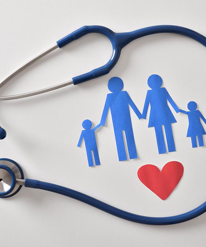 A stethoscope encircles a family of paper dolls and a red paper heart
