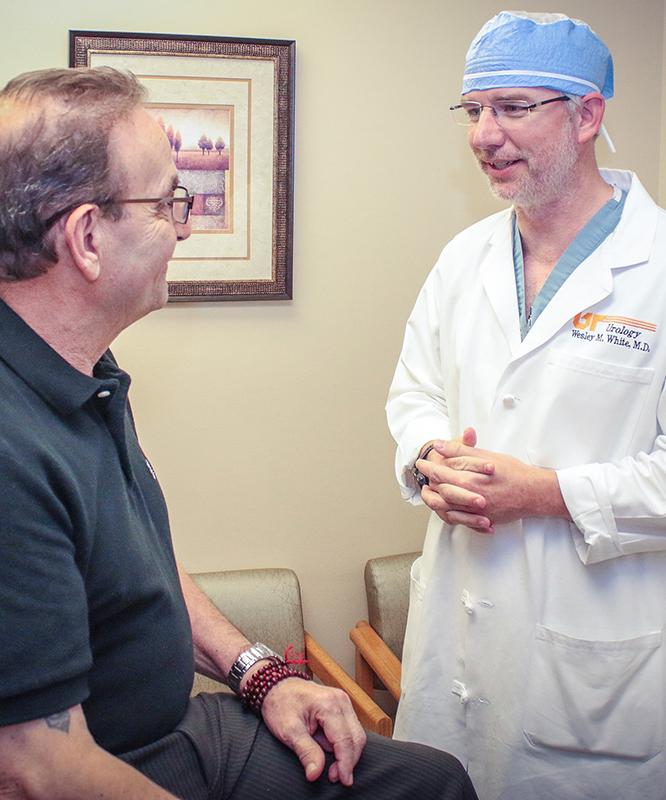Wes White MD, urologist, talks with a patient