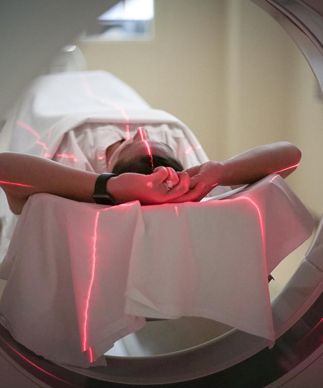 A patient lies in a CT scanner during a scan